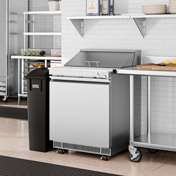 An Avantco 1 door front breathing refrigerated sandwich prep table on a stainless steel counter.