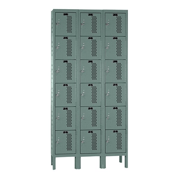 A close-up of a Hallowell gray triple 6-tier box locker with six compartments.