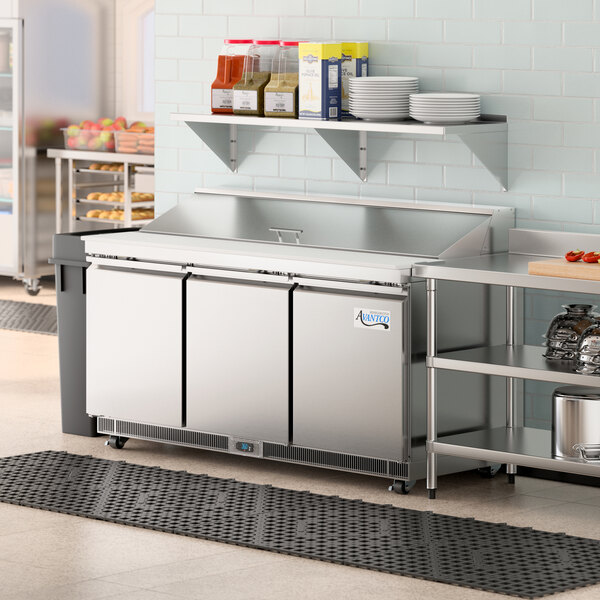 An Avantco refrigerated sandwich prep table with a stainless steel cutting top.