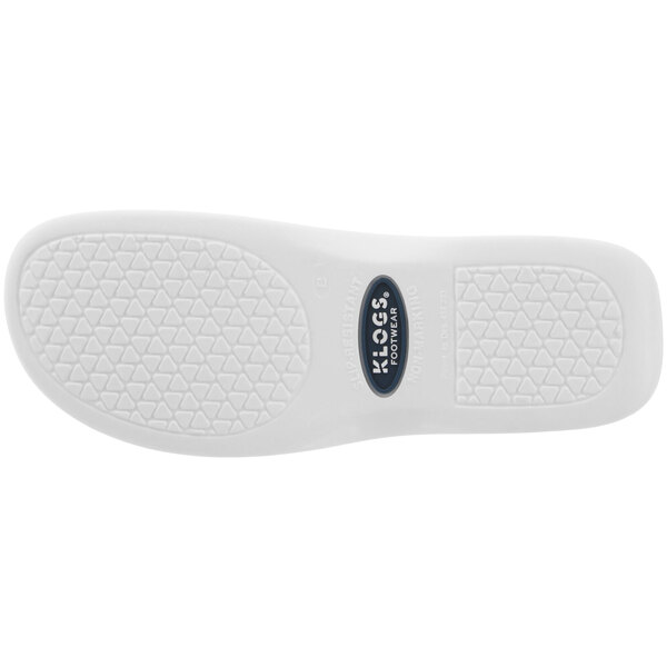 A close-up of a white Klogs Boca women's clog with a white rubber sole with a logo and triangle pattern.