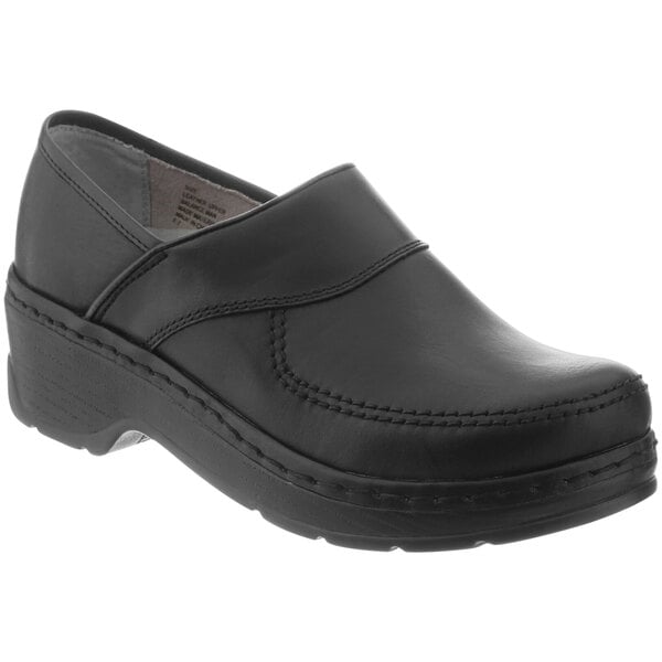 A pair of black leather Klogs clogs with rubber soles.