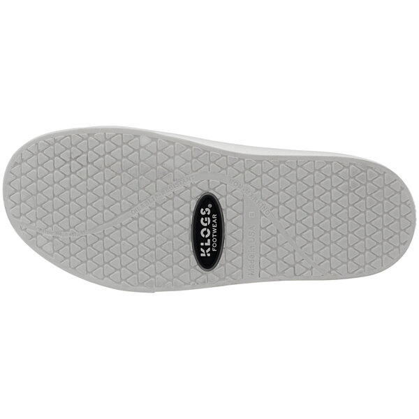 A close-up of a white Klogs shoe with a white sole and a logo on the sole.