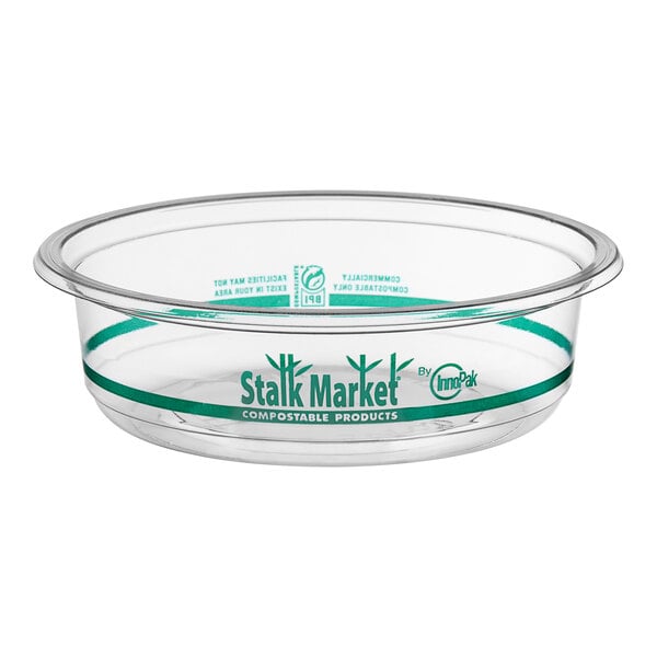 A clear plastic Stalk Market deli container with green trim.