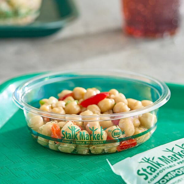 A clear Stalk Market deli container filled with food on a tray.