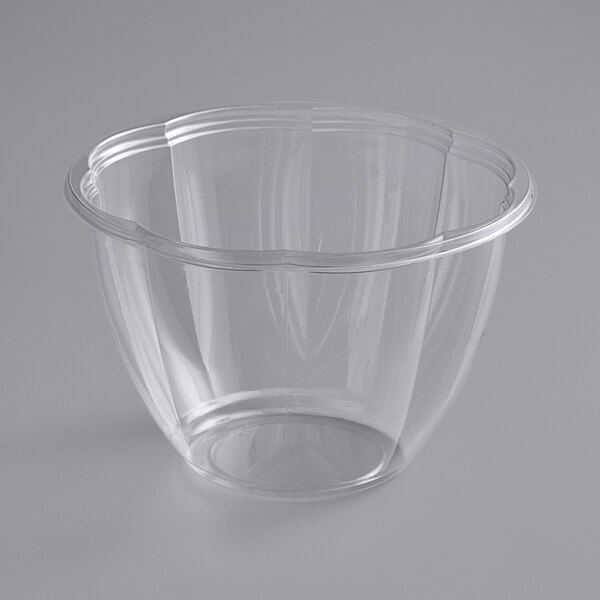 A Stalk Market clear plastic salad bowl on a white surface.