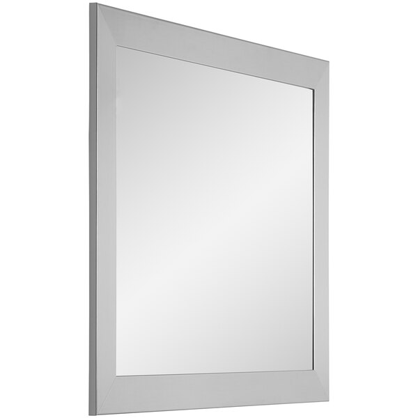 A stainless steel rectangular mirror with a silver frame on a wall.
