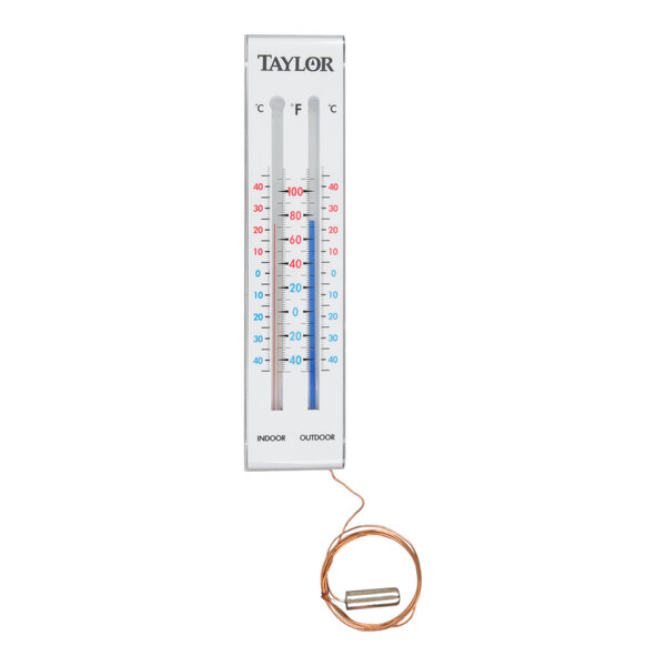 A rectangular indoor/outdoor thermometer with two vertical temperature scales and a coiled wire attached to a metal probe at the bottom.