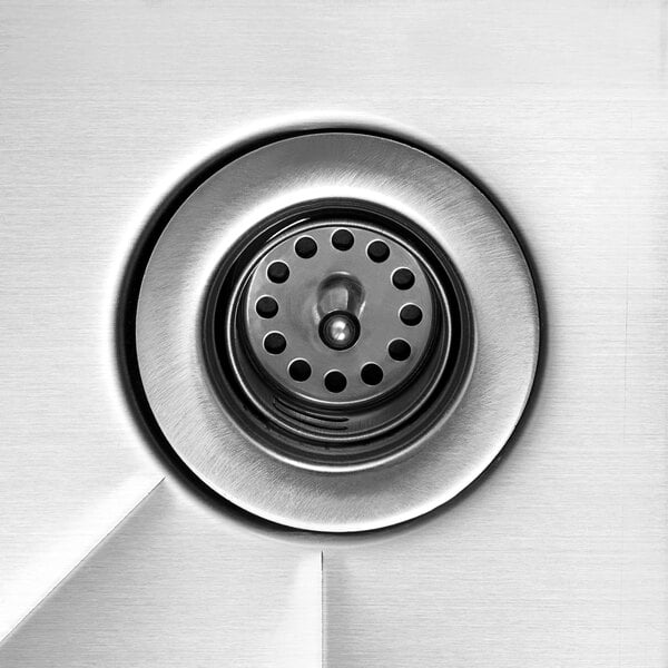 A close up of the stainless steel drain on a Steelton underbar dump sink.