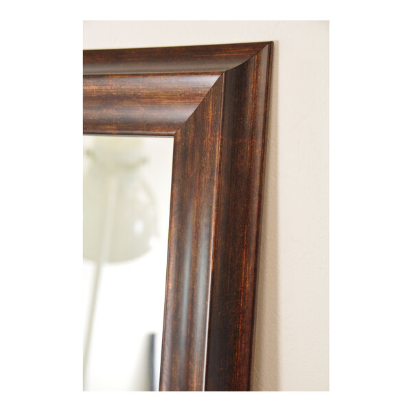 A close-up of a BrandtWorks copper brown mirror with a white frame.
