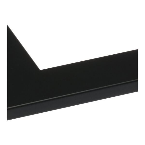 The black corner of a BrandtWorks matte black mirror.