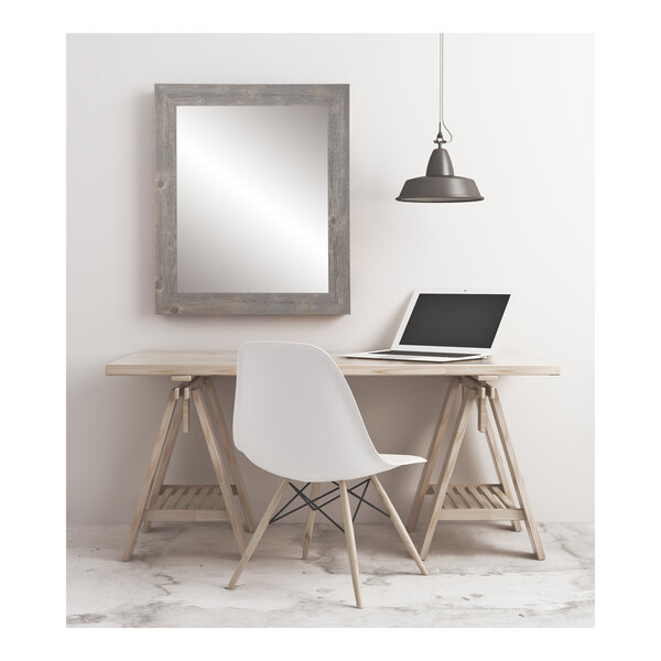 A white desk with a BrandtWorks barnwood gray finish mirror over it.