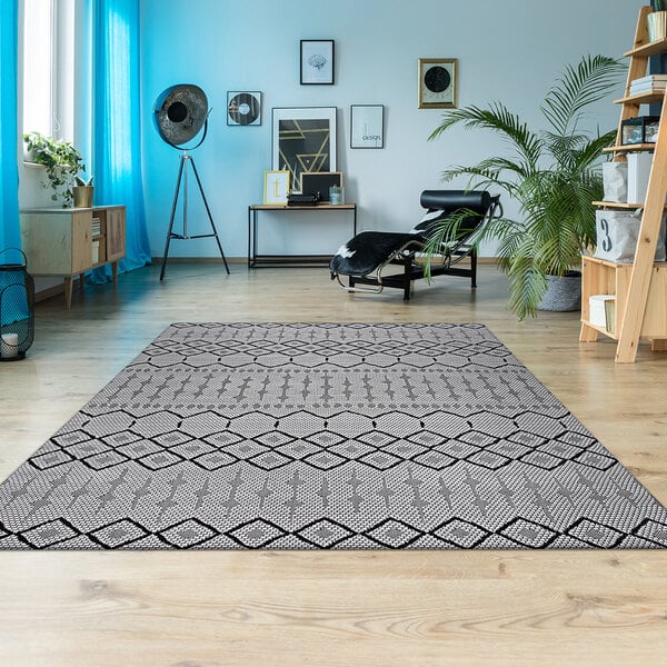 A Couristan Afuera Hadron runner rug with a modern geometric pattern in a room.