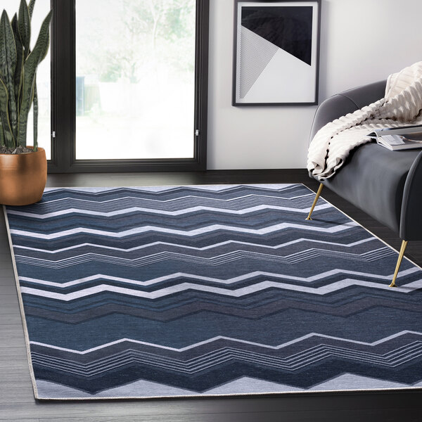 An Abani Parker Collection blue modern zig zag area rug with a pattern on it.