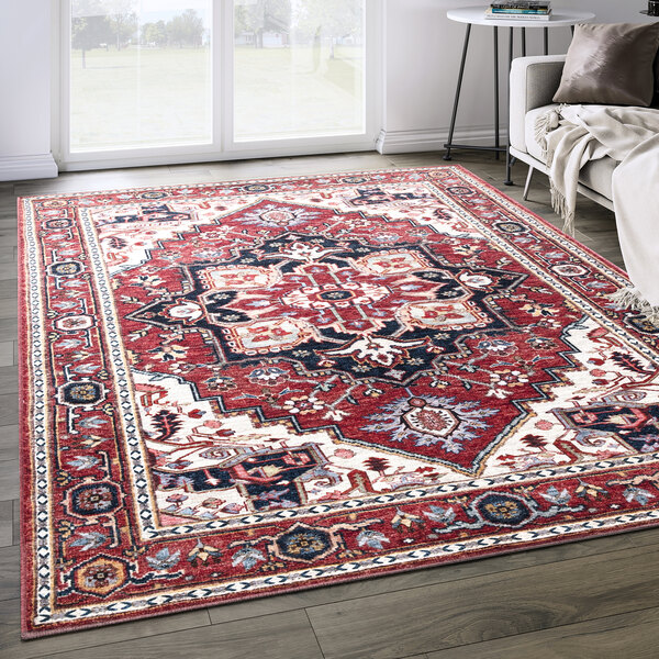 An Abani Molana Collection red vintage traditional medallion area rug on a wood floor.