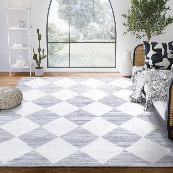 An Abani Parker Collection gray modern geometric diamond area rug in a room with a couch.