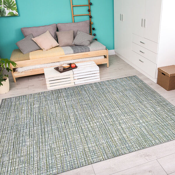 An ivory and hunter green Couristan runner rug in a room with a bed.