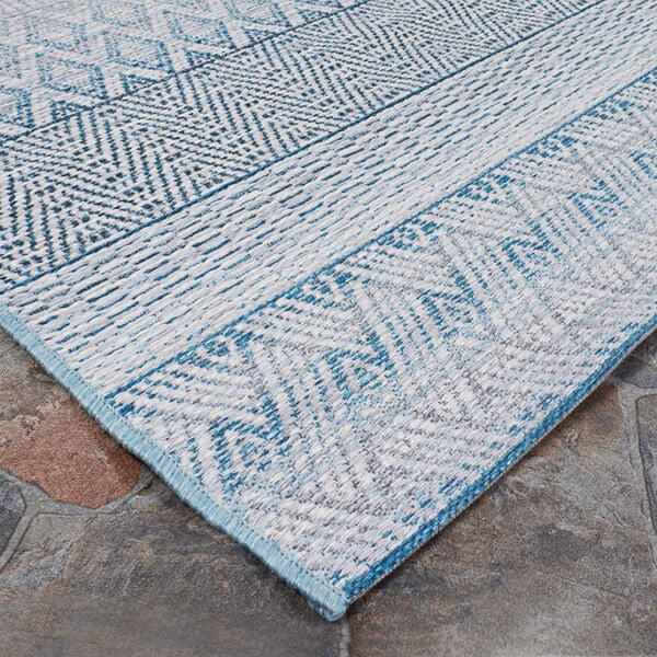 A close-up of a blue and white Couristan Cape Gables surf area rug.