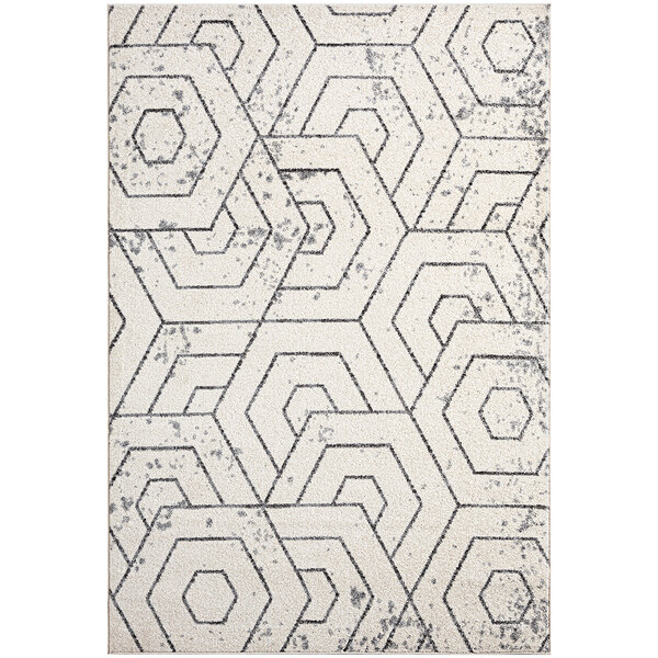 A white and grey area rug with hexagons and geometric shapes in black.