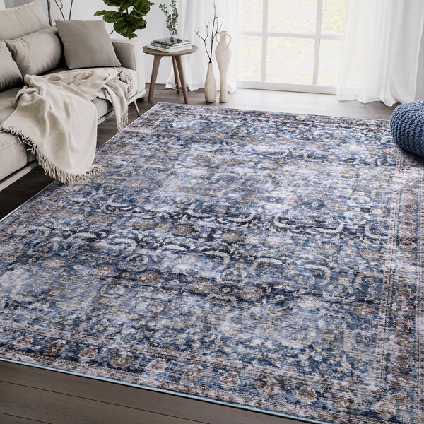 An Abani Lola Collection blue and brown area rug with a blue and grey design in a room.