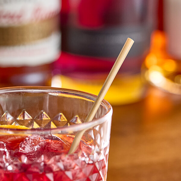 A drink in a glass with a HAY! wheat straw.
