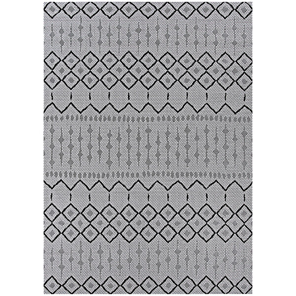 A Couristan Hadron area rug with a black and white geometric pattern.