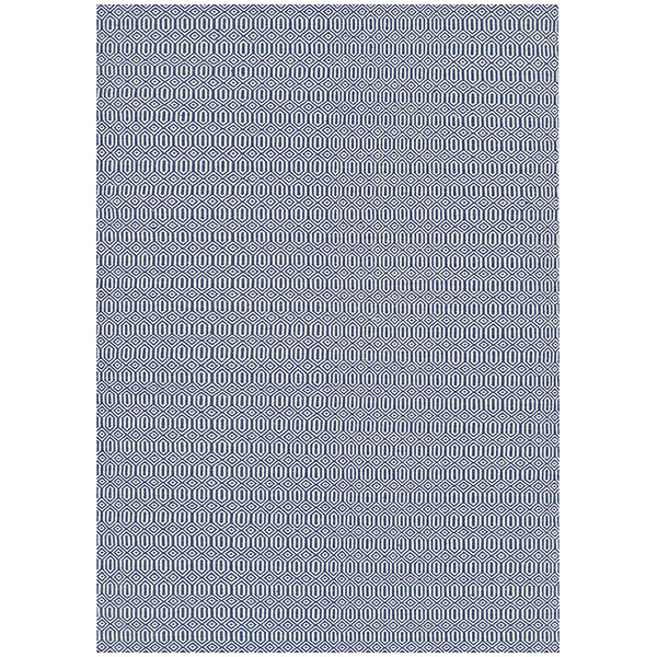 A white area rug with a blue pattern of circles.