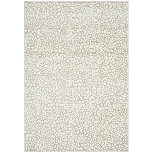 A cream and beige area rug with a cheetah print pattern.