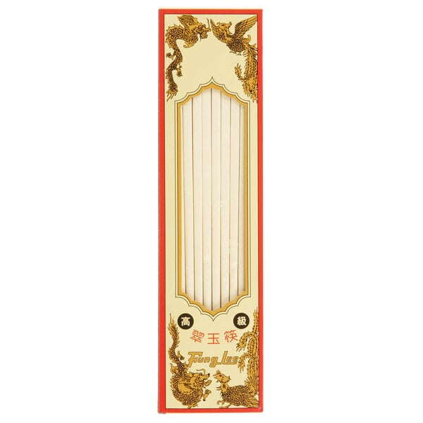 A white box with red and gold writing on it containing ivory plastic chopsticks with a dragon design.