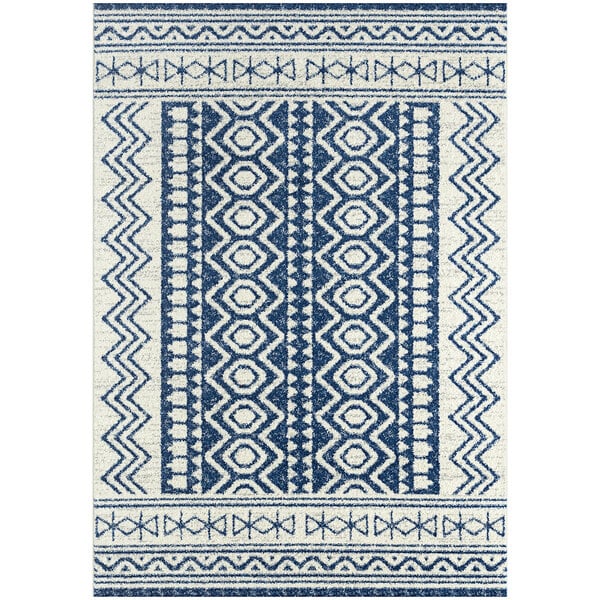 A navy and cream rug with geometric designs in blue and white.