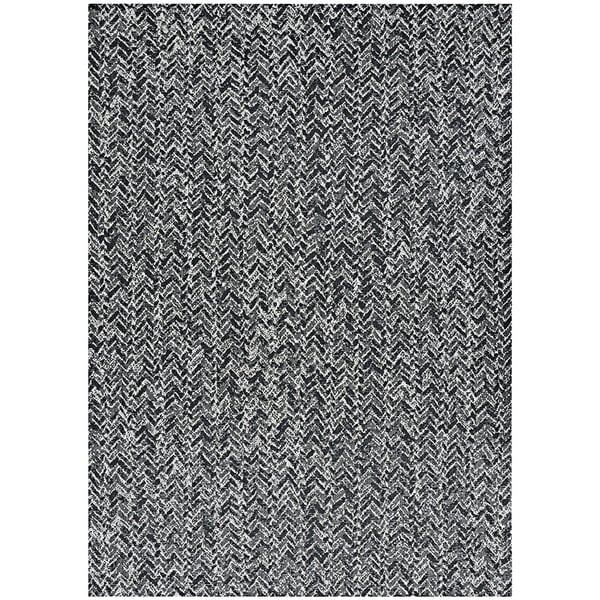 A Couristan Afuera Herringbone area rug in onyx and shell with a black and white herringbone pattern.