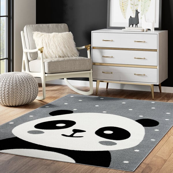 An Abani Play Collection gray panda area rug in a room with a white chair.