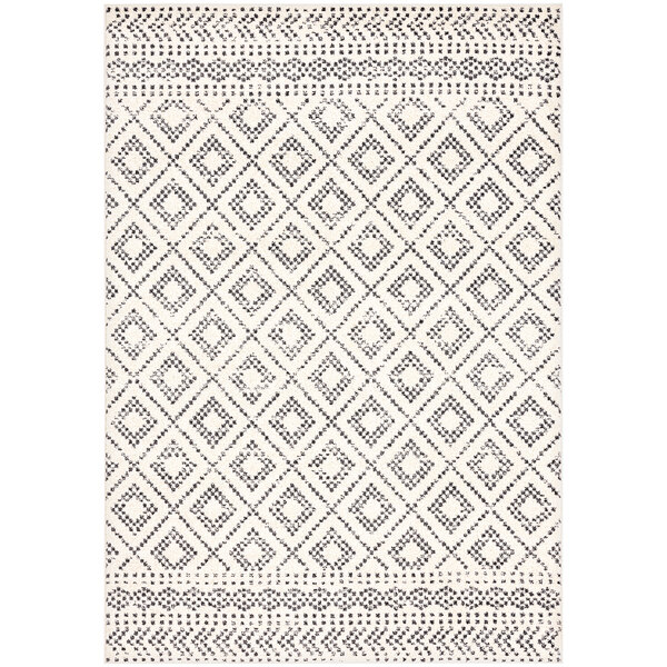 A cream and grey area rug with a Moroccan pattern.