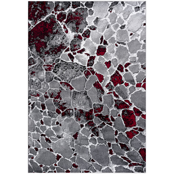 A close-up of a gray and red Abani Arto Collection area rug with a stone pattern.