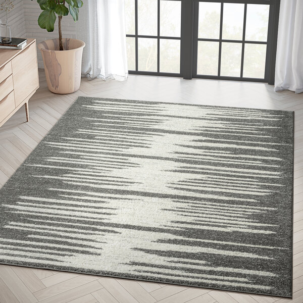 An Abani Casa Collection Cream and Gray Geometric Area Rug with a jagged design in a room.