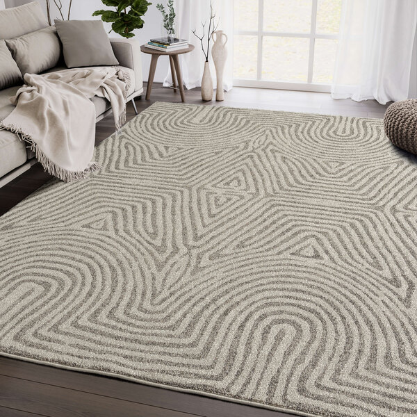 An Abani Layla Collection beige and brown geometric area rug in a room.