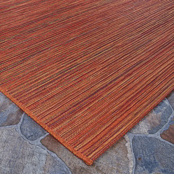 A close up of the Couristan Cape Hinsdale Crimson Multi-Colored Area Rug with orange stripes.
