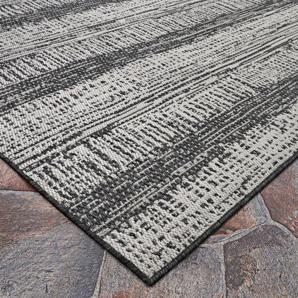 A close up of a Couristan Everhome Tangent area rug with a black and white pattern.
