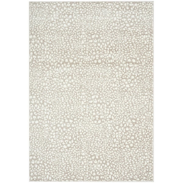 An Abani Arto Collection cream and beige area rug with a cheetah print pattern.