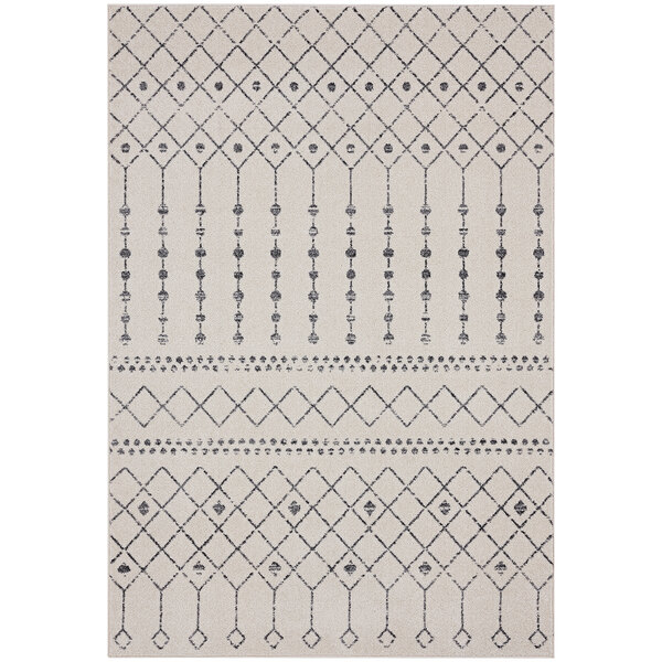 A close up of a cream and gray Moroccan trellis area rug with a geometric pattern.