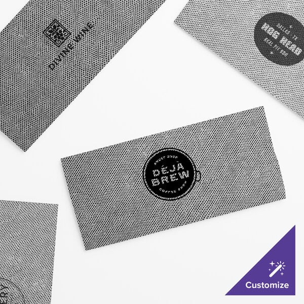 Choice Touchstone black paper guest towels with the logo of the company in white on them.