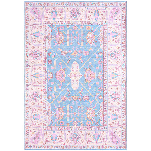 An Abani Molana Collection pink and blue area rug with ornate designs.