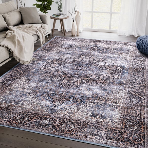 An Abani Lola Collection brown and blue vintage floral medallion area rug.