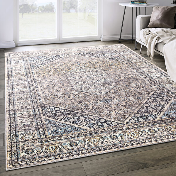 An Abani Lola Collection brown vintage geometric medallion area rug on a floor.