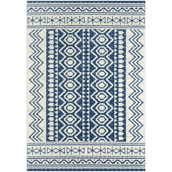 An Abani Casa Collection navy and cream area rug with a geometric pattern in blue and white.