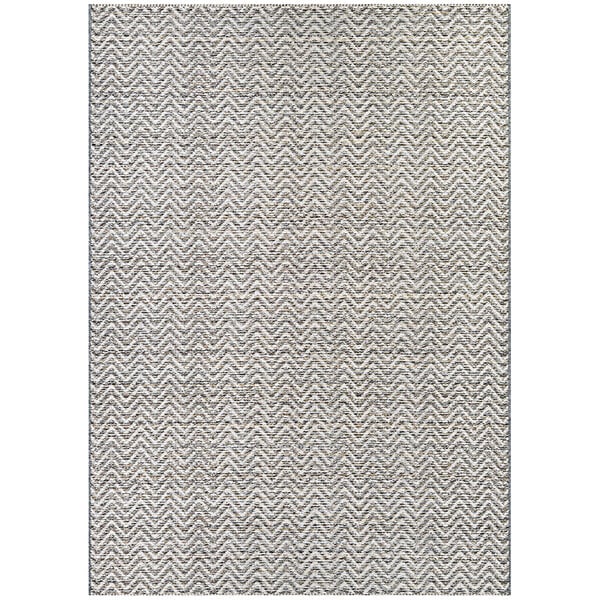 A Couristan Cape Marion area rug with a chevron pattern in light brown and ivory.