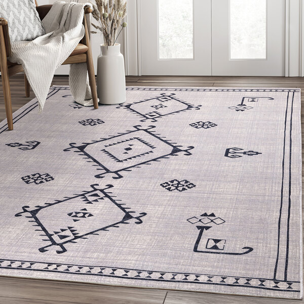 An Abani Molana Collection cream and gray area rug with a geometric Moroccan folk design.