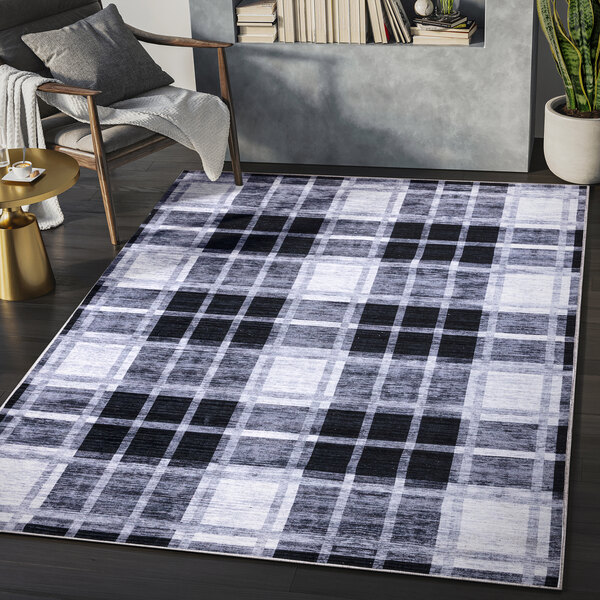 A cream and gray plaid area rug in a room.
