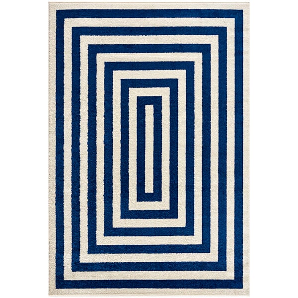 A navy and cream geometric rectangular area rug.