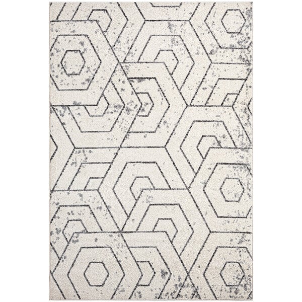 A gray rug with white hexagons in a geometric pattern.