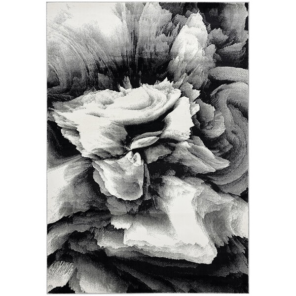 A close up of a black and white Abani Arto Collection Liquid Marble area rug.